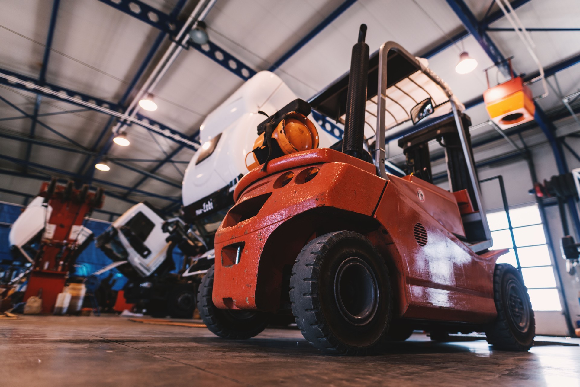 Picture of forklift in car repairing workshop.