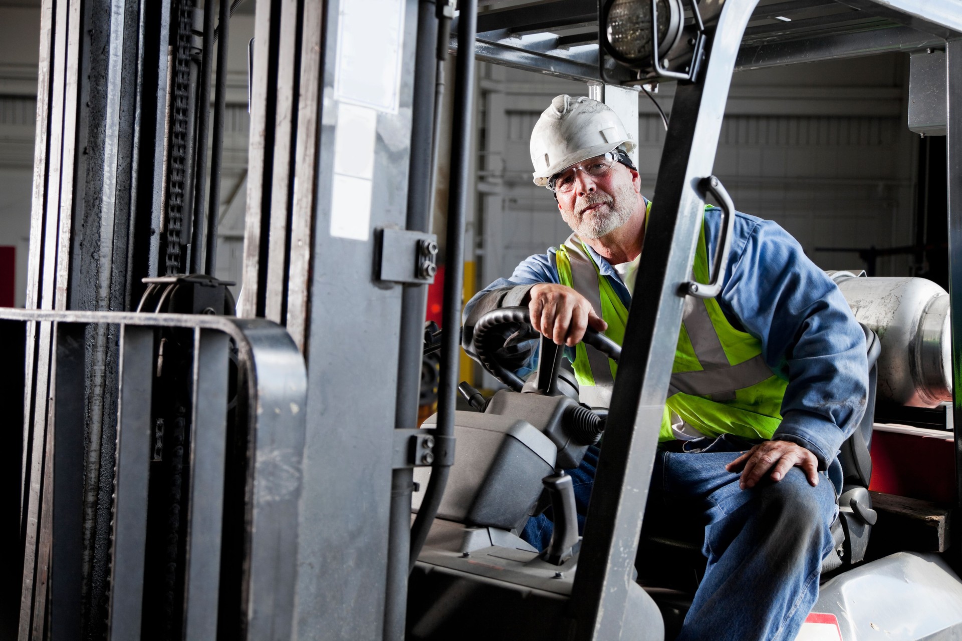 Worker driving forklift