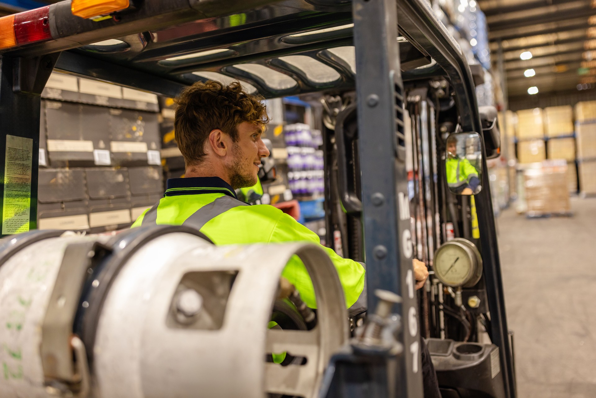 Men in Sydney warehouse managing e-commerce distribution and examining merchandise with specialist equipment
